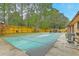 Backyard view of the pool with pool cover and privacy fence at 201 Hunt Club Dr, Summerville, SC 29485