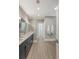 Bathroom featuring double vanity sinks, large shower with glass door and grey tile floors at 2037 Shell Ring Cir, Mount Pleasant, SC 29466