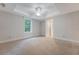 Bright bedroom with tray ceiling, ceiling fan, large window and neutral carpet at 2037 Shell Ring Cir, Mount Pleasant, SC 29466
