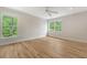Spacious bedroom with hardwood floors, neutral walls, two windows and a ceiling fan at 2037 Shell Ring Cir, Mount Pleasant, SC 29466