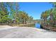 A concrete boat ramp leads to a waterway lined with palm trees and lush greenery under a clear blue sky at 2037 Shell Ring Cir, Mount Pleasant, SC 29466