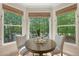 Sunlit breakfast nook featuring a round table with seating for two with an outdoor view framed by three large windows at 2037 Shell Ring Cir, Mount Pleasant, SC 29466