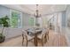 Well-lit dining room with a modern chandelier, seating for six, and large windows at 2037 Shell Ring Cir, Mount Pleasant, SC 29466