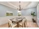 Charming dining room with wainscoting, stylish chandelier, and a wooden table set for six at 2037 Shell Ring Cir, Mount Pleasant, SC 29466