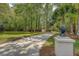 Long, elegant driveway leading to a home nestled amidst lush trees and impeccable landscaping at 2037 Shell Ring Cir, Mount Pleasant, SC 29466