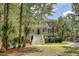 Stately two-story home featuring a welcoming front porch, white stairs, and mature landscaping at 2037 Shell Ring Cir, Mount Pleasant, SC 29466