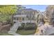 Stately two-story home with double porches and meticulous landscaping boasts a luxurious appeal at 2037 Shell Ring Cir, Mount Pleasant, SC 29466
