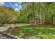 Lush green front yard with a long driveway leading to a beautiful home surrounded by tall trees at 2037 Shell Ring Cir, Mount Pleasant, SC 29466