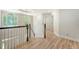 Upstairs hallway with hardwood floors and white walls, featuring a transom window at 2037 Shell Ring Cir, Mount Pleasant, SC 29466