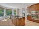 This kitchen features stainless steel appliances, wood cabinets, hardwood floors, and a sunlit breakfast nook at 2037 Shell Ring Cir, Mount Pleasant, SC 29466