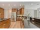 This kitchen features stainless steel appliances, wood cabinets, hardwood floors, and granite countertops at 2037 Shell Ring Cir, Mount Pleasant, SC 29466