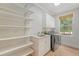 Functional laundry room featuring a utility sink, shelving, modern washer/dryer, and a window at 2037 Shell Ring Cir, Mount Pleasant, SC 29466