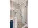 Elegant shower with white subway tile, seamless glass door, rainfall shower head, and hexagon tile floor at 2037 Shell Ring Cir, Mount Pleasant, SC 29466