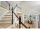 Open staircase with dark wood banister overlooks dining room with coffered ceiling at 2037 Shell Ring Cir, Mount Pleasant, SC 29466