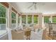 This sunroom features ample natural light, comfortable seating, hardwood floors, and a view of the outdoor deck at 2037 Shell Ring Cir, Mount Pleasant, SC 29466