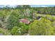 Aerial view of a home and outbuildings surrounded by mature trees and a vast, forested property at 2080 Sniders Hwy, Walterboro, SC 29488