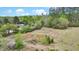 A serene view of the property showcasing the home and surrounding wooded landscape, ideal for peaceful living at 2080 Sniders Hwy, Walterboro, SC 29488
