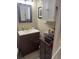 This bathroom has a vanity with dark wood cabinet, white countertop and medicine cabinet at 210 Ellen St, Goose Creek, SC 29445