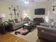 Comfortable living room featuring plush seating, hardwood floors, a large TV, and a cozy atmosphere with warm lighting at 210 Ellen St, Goose Creek, SC 29445