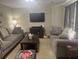 Spacious living room with two comfortable sofas, hardwood floors, a large TV, and plenty of room for entertaining guests at 210 Ellen St, Goose Creek, SC 29445