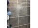 Close-up on neutral-toned tiled shower walls with metal shower caddy at 210 Ellen St, Goose Creek, SC 29445