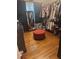 This walk-in closet offers plenty of clothing storage and red ottoman at 210 Ellen St, Goose Creek, SC 29445