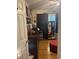 A well-appointed walk-in closet with a dark wood dresser, mirror and red ottoman at 210 Ellen St, Goose Creek, SC 29445