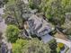 Aerial view of a beautiful house with a deck, landscaped backyard, and a winding driveway at 2104 Royal Pine Dr, Seabrook Island, SC 29455