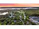 Gorgeous sunset aerial view of a neighborhood with a river and large field for recreational activities at 2104 Royal Pine Dr, Seabrook Island, SC 29455