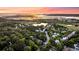 Picturesque aerial view with sunset of the neighborhood and lake at 2104 Royal Pine Dr, Seabrook Island, SC 29455