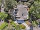 Overhead view of a well-maintained home featuring a deck, landscaped grounds, and winding driveway at 2104 Royal Pine Dr, Seabrook Island, SC 29455