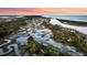 Stunning aerial of winding waterways and houses surrounded by green trees near the ocean at 2104 Royal Pine Dr, Seabrook Island, SC 29455