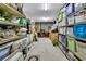 Organized basement storage with shelving units filled with bins, boxes, and household items on a concrete floor at 2104 Royal Pine Dr, Seabrook Island, SC 29455