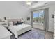 Bright bedroom featuring neutral walls, white wood trim, a ceiling fan and natural light from large windows at 2104 Royal Pine Dr, Seabrook Island, SC 29455