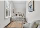 Cozy bedroom featuring natural light from a large window with shutters and a stylish white metal bed frame at 2104 Royal Pine Dr, Seabrook Island, SC 29455