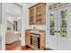 Butler pantry featuring wine refrigerator, granite counters and glass door upper cabinets at 2104 Royal Pine Dr, Seabrook Island, SC 29455