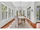 Sunny dining room with many windows and a long white dining table with seating at 2104 Royal Pine Dr, Seabrook Island, SC 29455