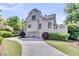 Home exterior featuring well-manicured lawn, circular driveway, and an attached three-car garage at 2104 Royal Pine Dr, Seabrook Island, SC 29455