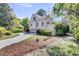 Home exterior with well-maintained lawn, circular driveway, and attached three-car garage at 2104 Royal Pine Dr, Seabrook Island, SC 29455