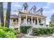 Charming home with inviting front porch, dormer windows, and manicured landscaping at 2104 Royal Pine Dr, Seabrook Island, SC 29455