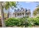 Inviting home with a welcoming front porch, dormer windows, and established greenery at 2104 Royal Pine Dr, Seabrook Island, SC 29455