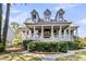 Attractive two-story home with front porch, dormer windows, and well-manicured landscaping, creating a welcoming curb appeal at 2104 Royal Pine Dr, Seabrook Island, SC 29455