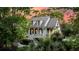 A charming two-story home with inviting porch, dormer windows, and lush landscaping set against a vibrant sky at 2104 Royal Pine Dr, Seabrook Island, SC 29455