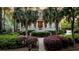 Inviting Southern-style home with a grand porch, mature landscaping, and palm trees framing the walkway at 2104 Royal Pine Dr, Seabrook Island, SC 29455