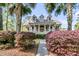 Beautiful home with columns, a large front porch, and lush landscaping at 2104 Royal Pine Dr, Seabrook Island, SC 29455