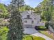 Home exterior view showing a circular driveway and a three-car garage with an attached outdoor deck space at 2104 Royal Pine Dr, Seabrook Island, SC 29455