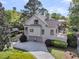 Beautiful home exterior with manicured lawn, a circular driveway, and an attached three-car garage at 2104 Royal Pine Dr, Seabrook Island, SC 29455