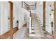 Bright foyer with staircase, hardwood floors, and stylish decor, leading to open living spaces and natural light at 2104 Royal Pine Dr, Seabrook Island, SC 29455