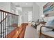 Upstairs hallway with hardwood floors, white walls, and a view into a bathroom at 2104 Royal Pine Dr, Seabrook Island, SC 29455