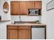 Compact kitchenette with wooden cabinets, a microwave, and a small refrigerator at 2104 Royal Pine Dr, Seabrook Island, SC 29455